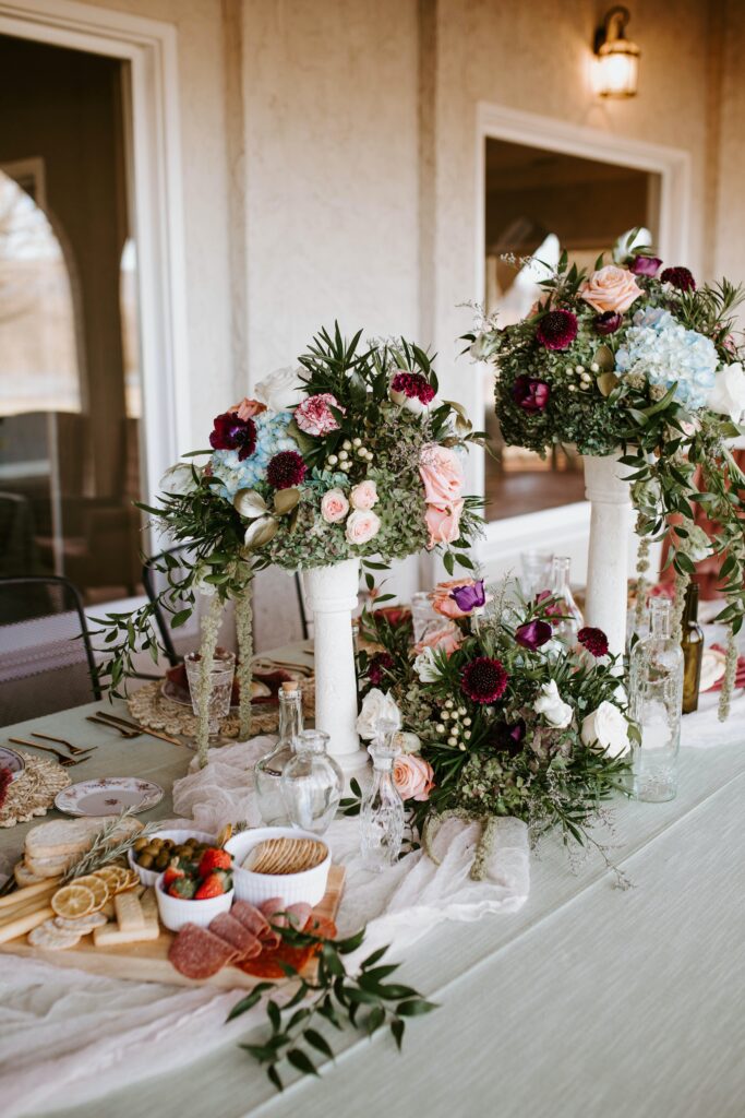 Compositions florales sur une table de réception avec bougies