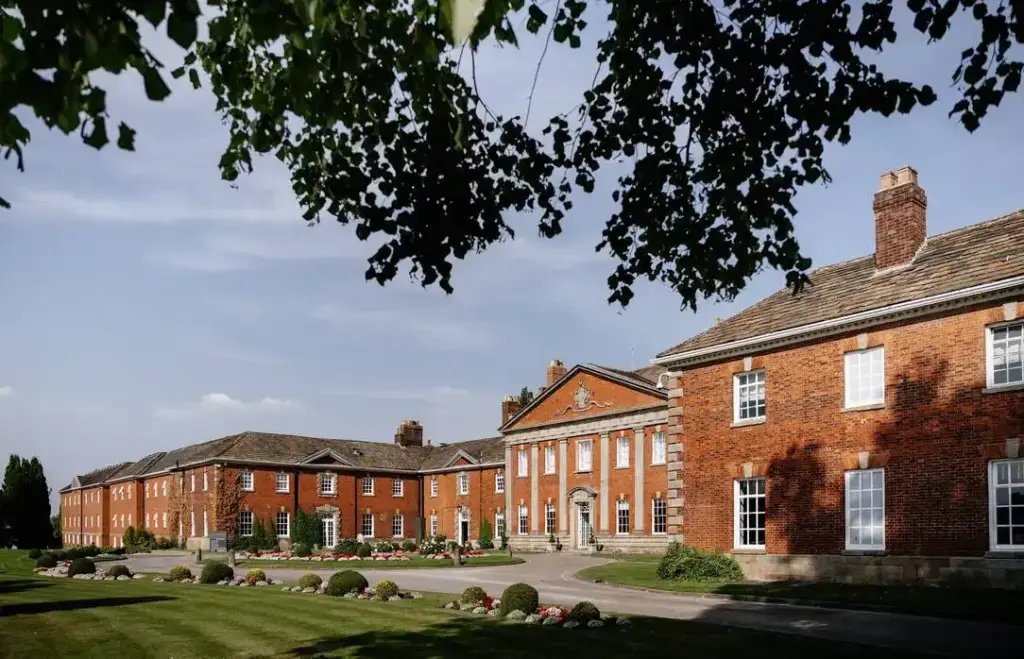 Georgian frontage of Mottram Hall viewed from its landscaped grounds
