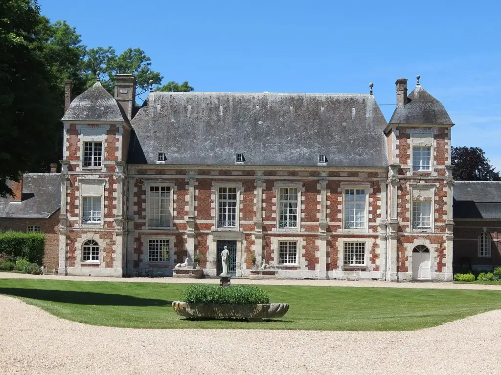 Brick and stone façade of Château de Bonnemare overlooking its courtyard and lawns (2017)