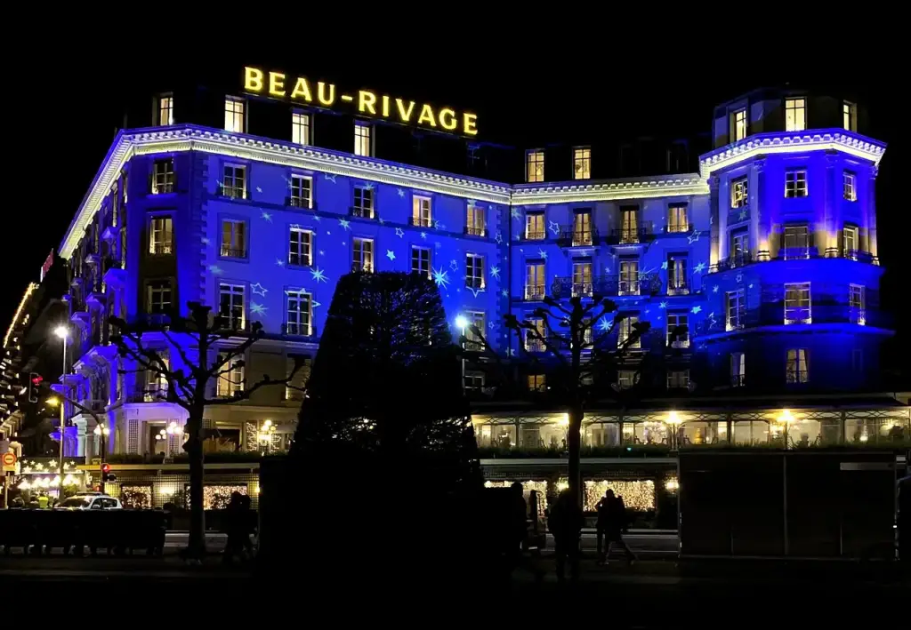 Beau-Rivage Genève façade illuminated at night on Quai du Mont-Blanc
