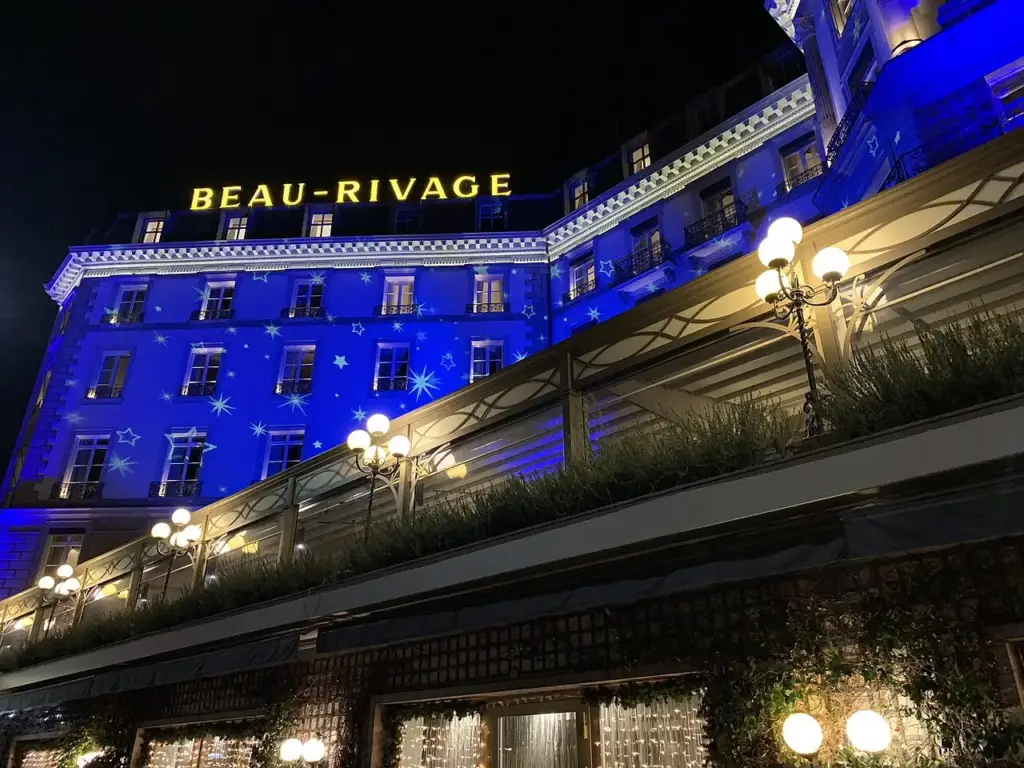 Low-angle view of the illuminated façade of Beau-Rivage Genève