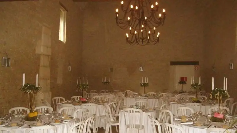 Room at Château de Merville set with round tables for a reception