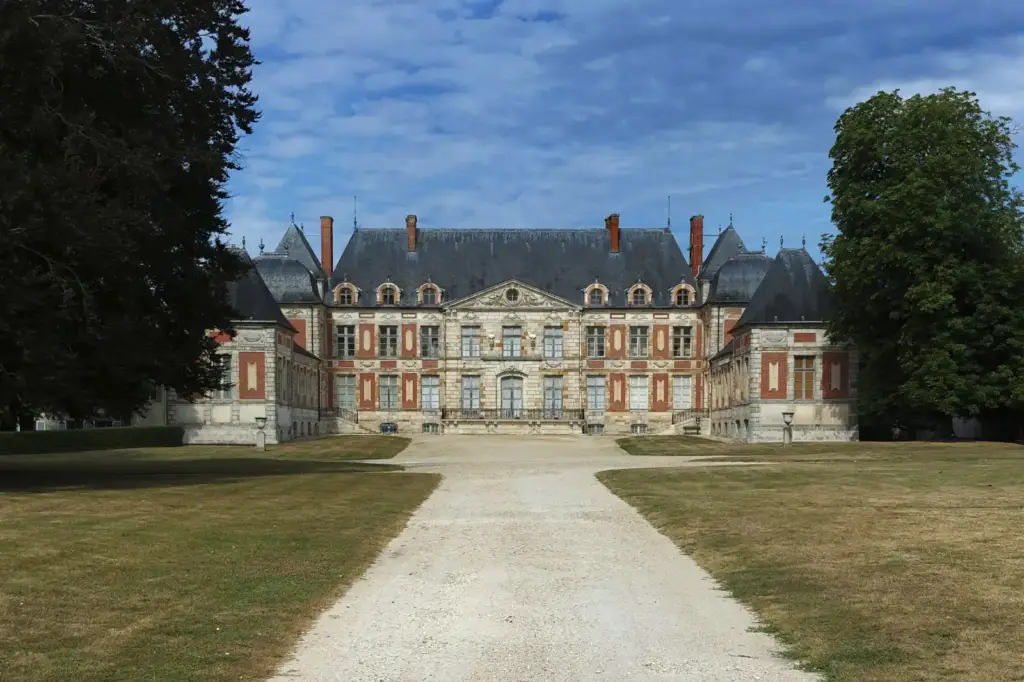 Main brick and stone façade of the château de Courson in Courson-Monteloup