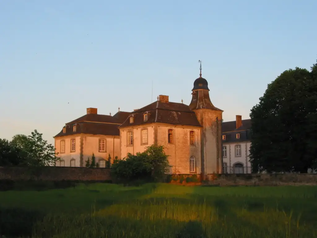 Façades and tower of Château de Deulin in evening sunlight, photographed in 2005