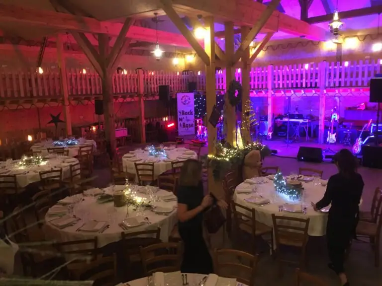The Saloon at Western City set for an evening reception, with round tables and coloured lighting.