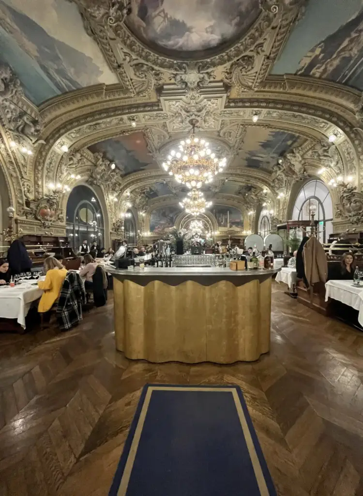 Gilded dining room and chandeliers at Le Train Bleu in Paris