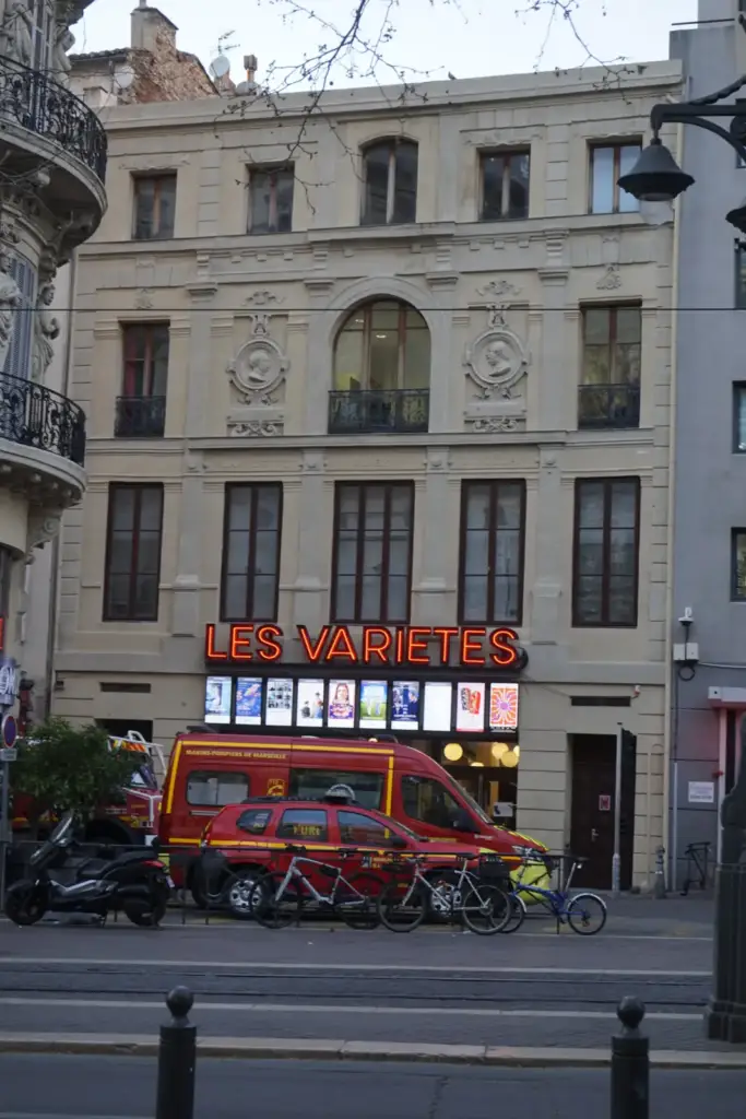 Façade and entrance of Les Variétés Cinema on rue Vincent Scotto in Marseille.