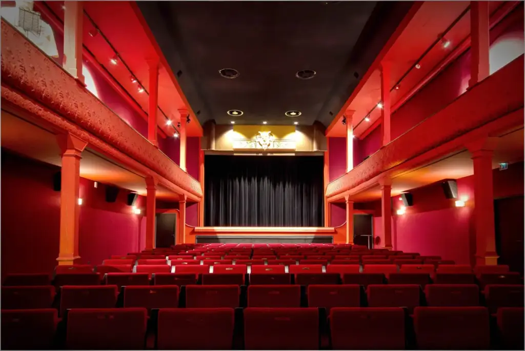 The empty Eden Théâtre auditorium in La Ciotat, with red seats and a closed curtain, photographed on 5 December 2021.
