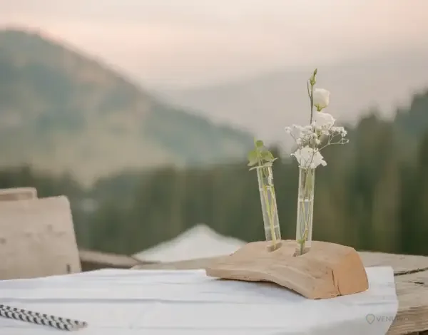 Table de mariage champêtre avec fleurs et paysage naturel