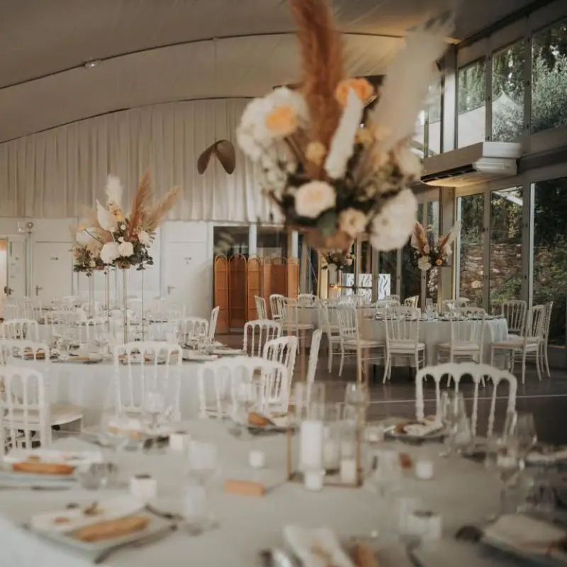 Salle Absolut du Château Pas du Cerf avec tables de mariage et grandes baies vitrées