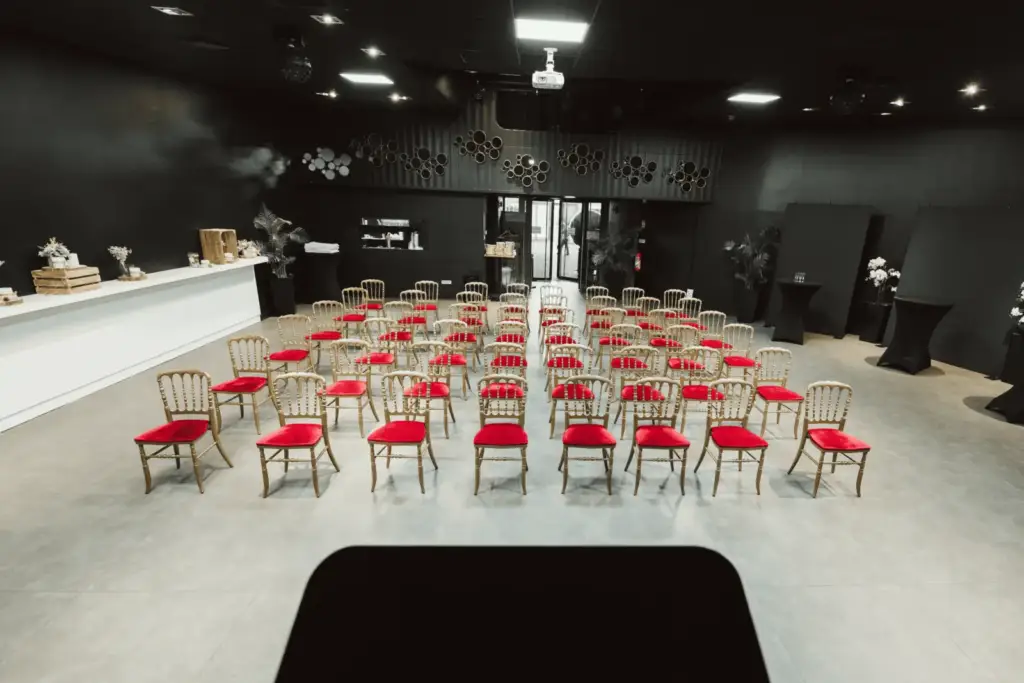The Grand’Place room arranged with rows of chairs and a stage